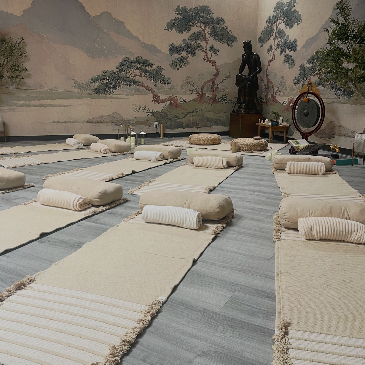 a room with many pillows on the floor