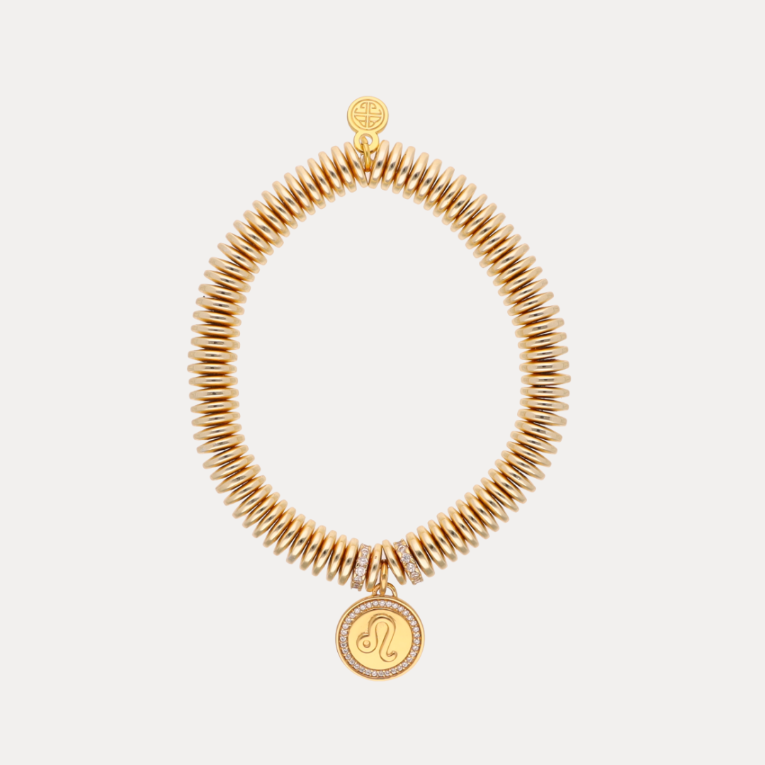 a gold bracelet with a pendant