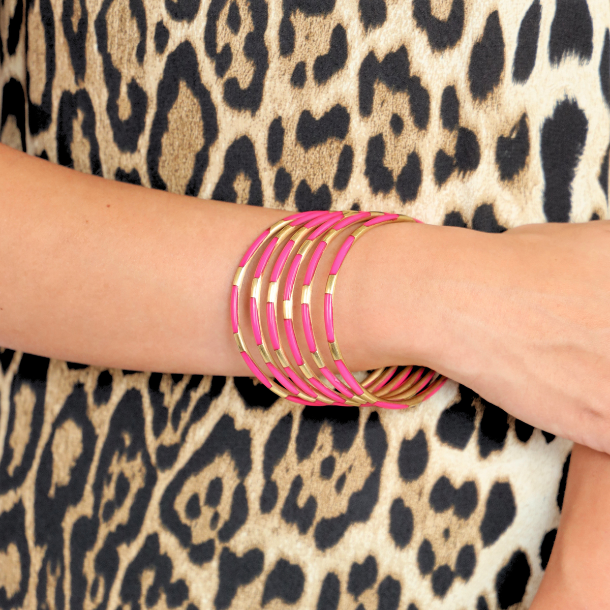 a person wearing pink bracelets
