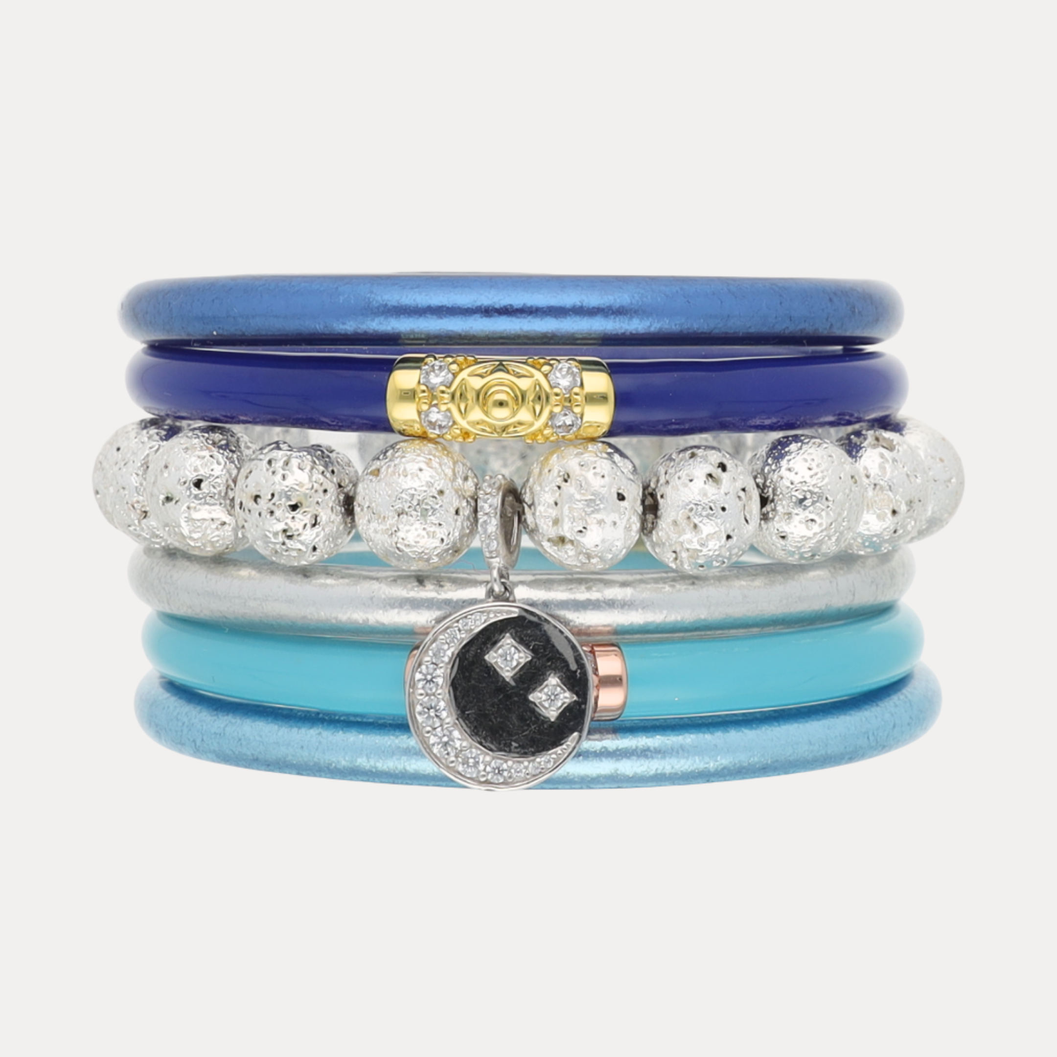 a stack of bracelets with a pendant