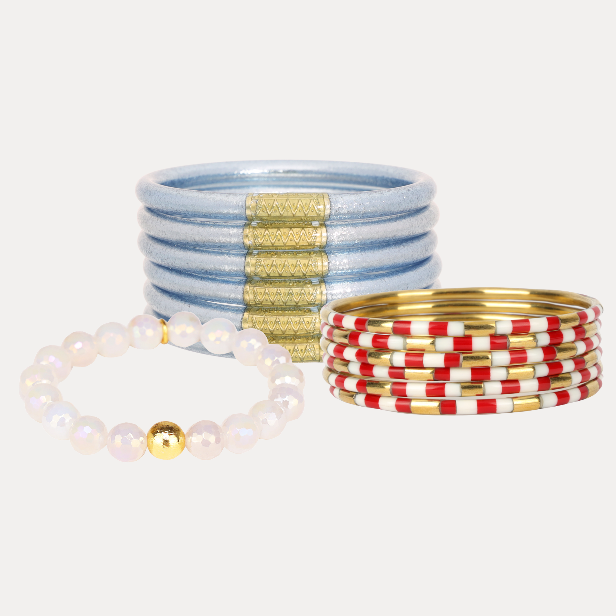 a group of bracelets and a pearl bracelet
