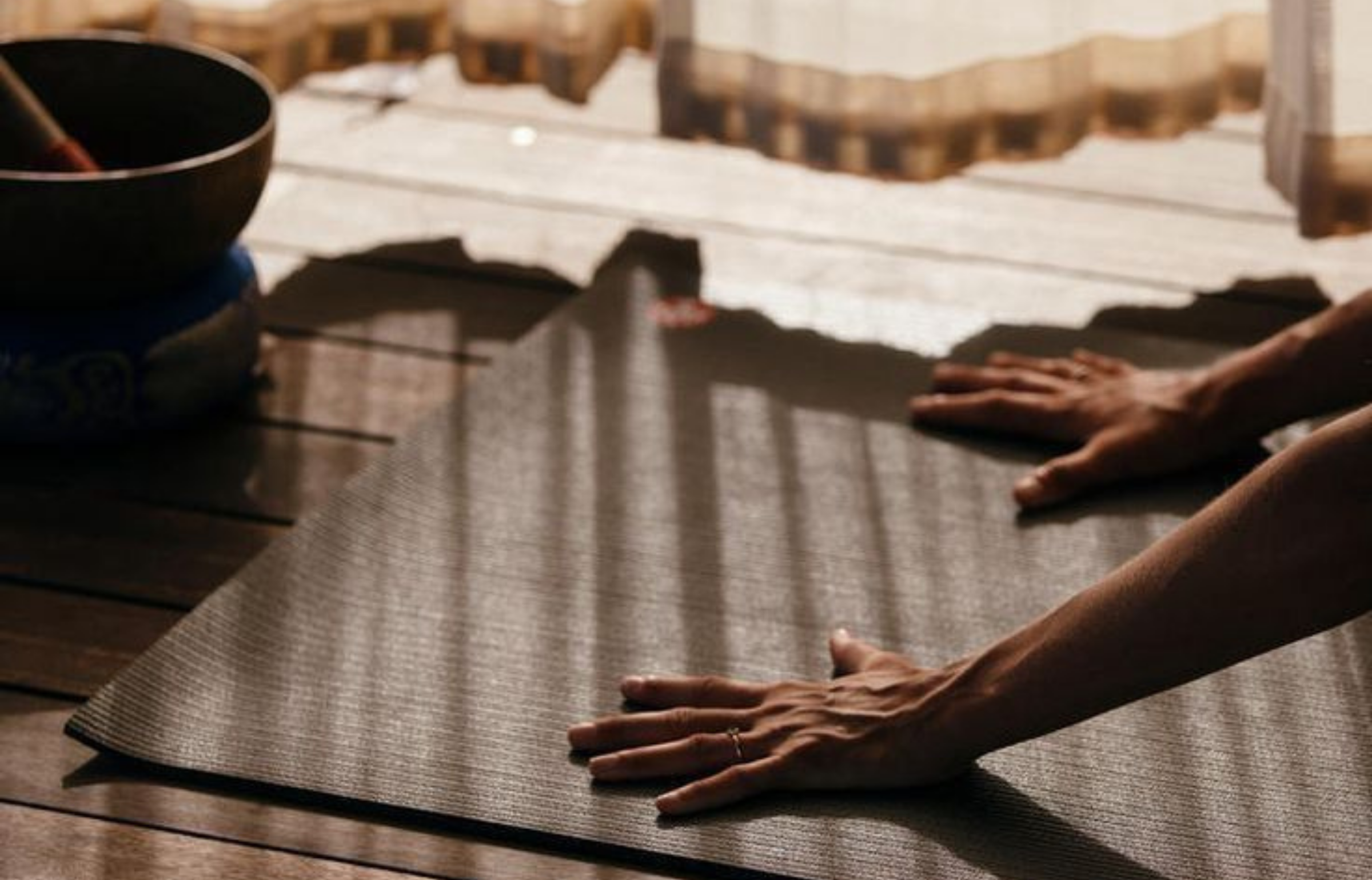 a person's hands on a mat