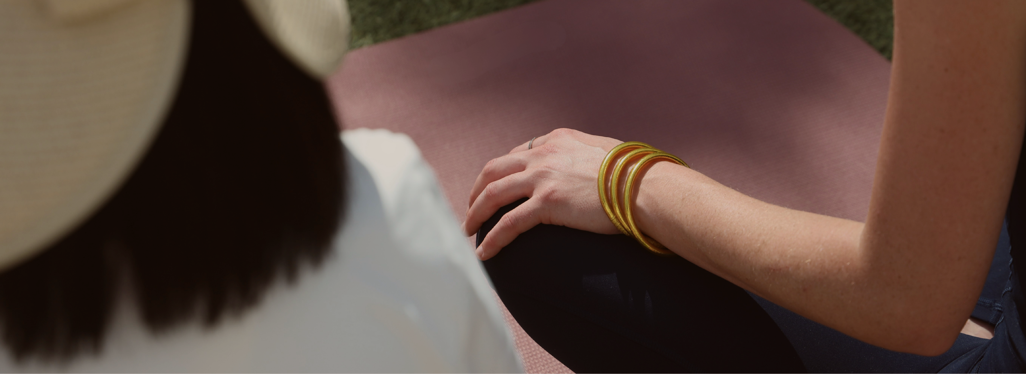 a hand with bracelets on a leg