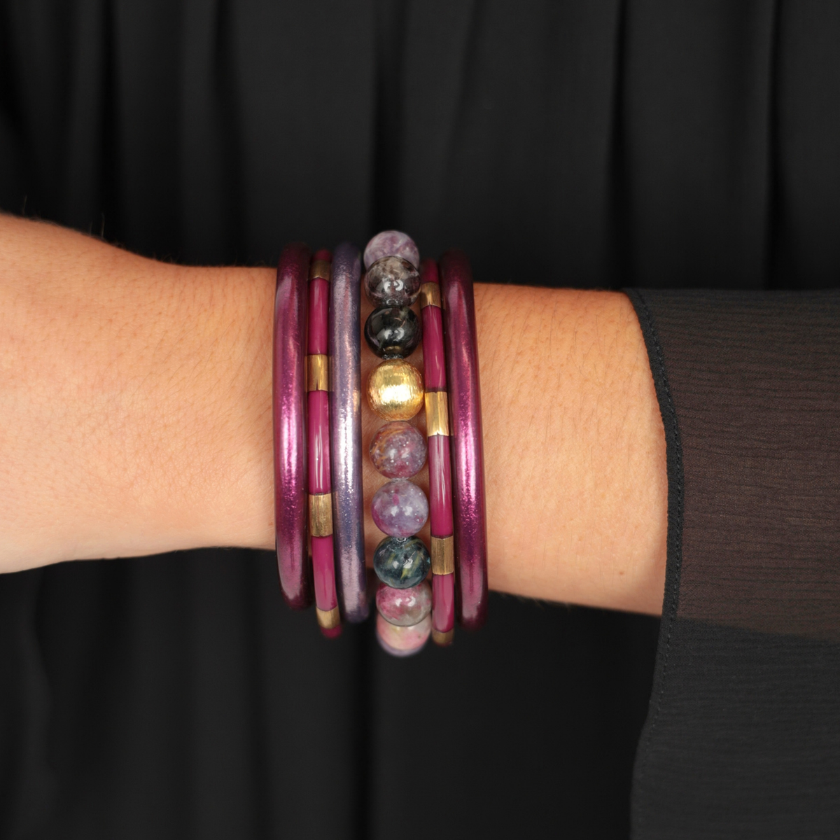 a person wearing bracelets on their wrist