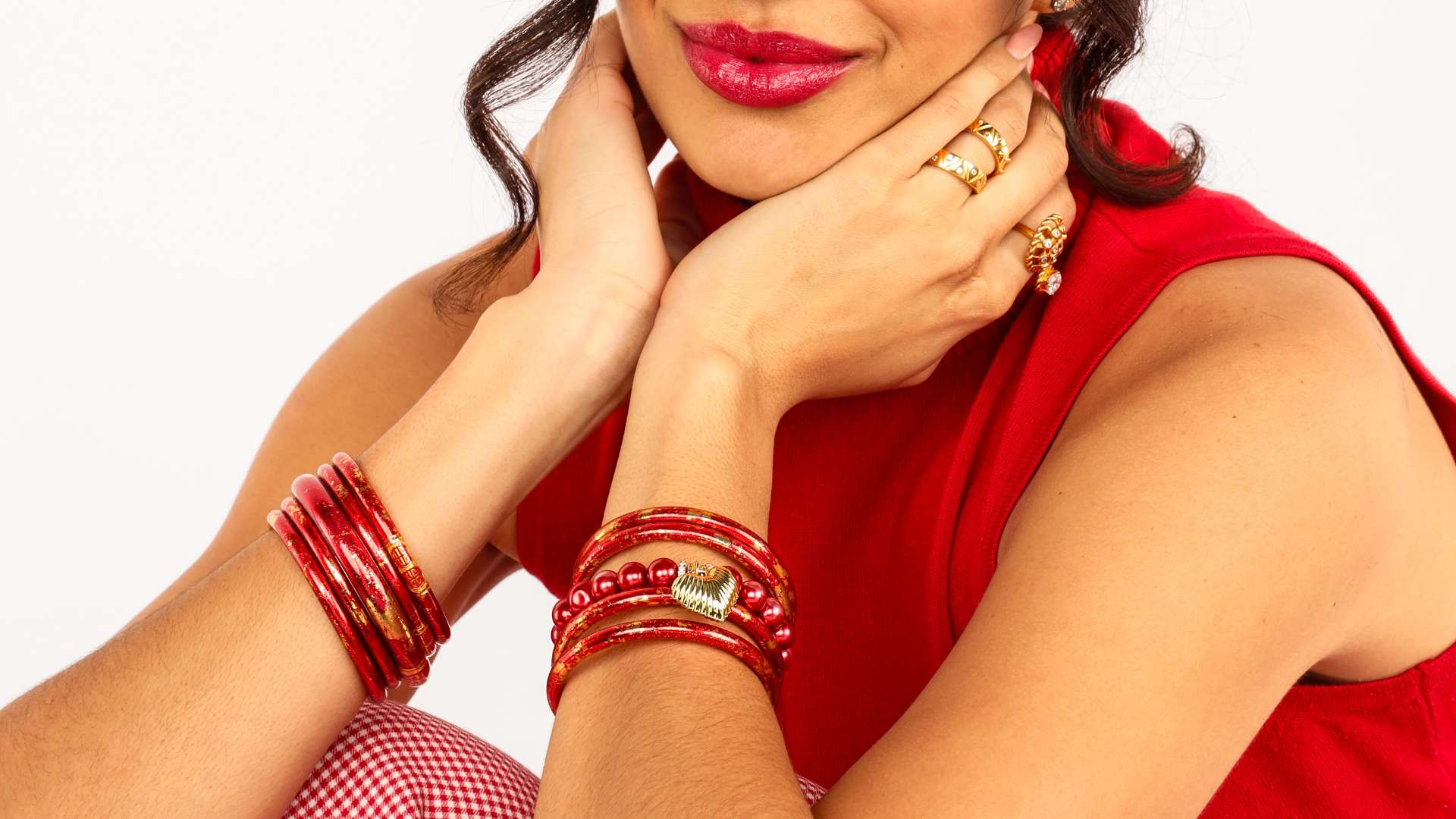 The BuDhaGirl Gift Guide | Gifts Under $100 | Woman Holding BuDhaGirl Red Silk Canister While Wearing Silver All Weather Bangles