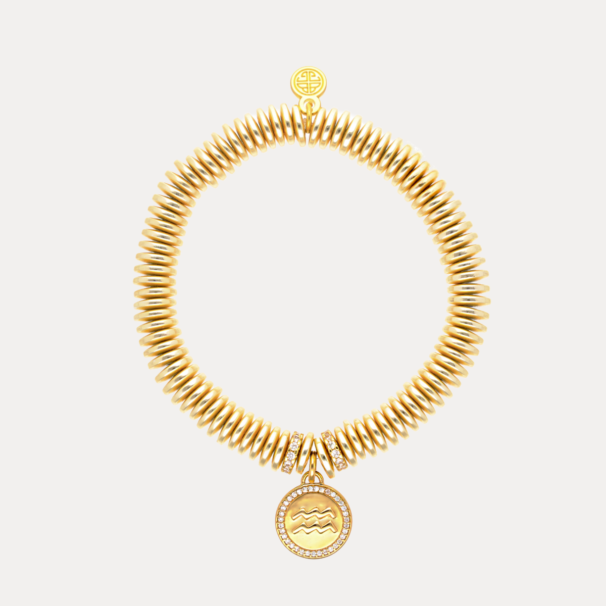 Gold necklace with a pendant on a light gray background