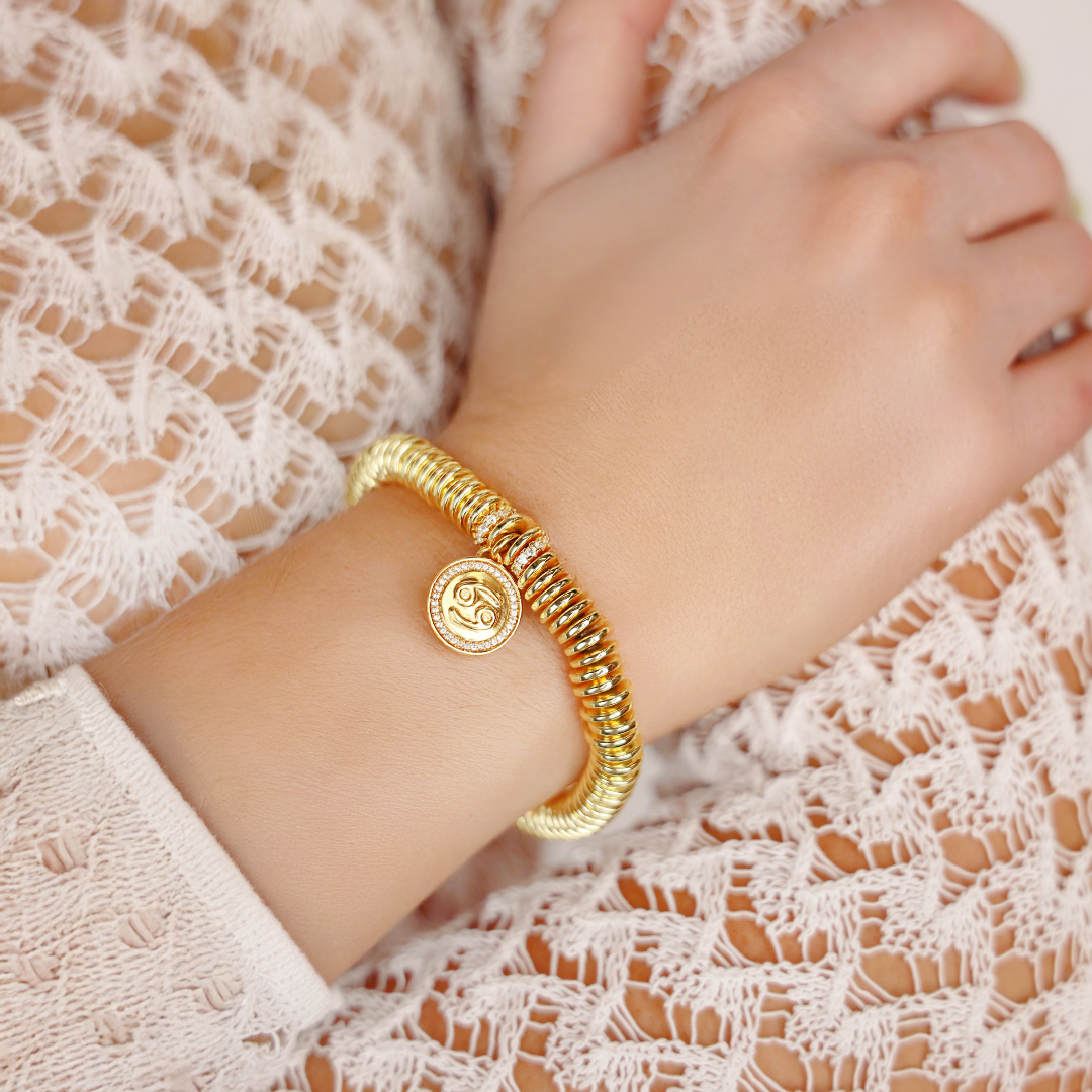 a person wearing a gold bracelet