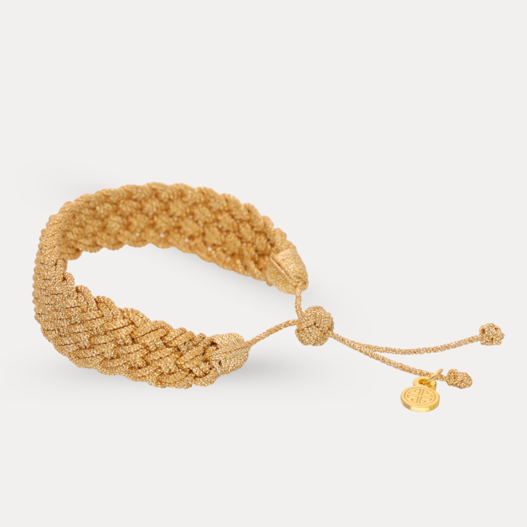 a gold bracelet with a knot