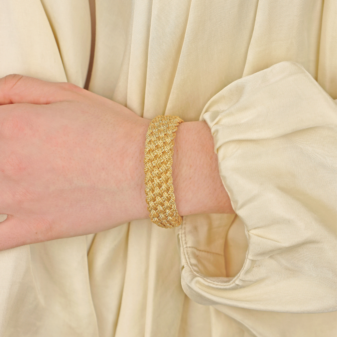 a person wearing a gold bracelet