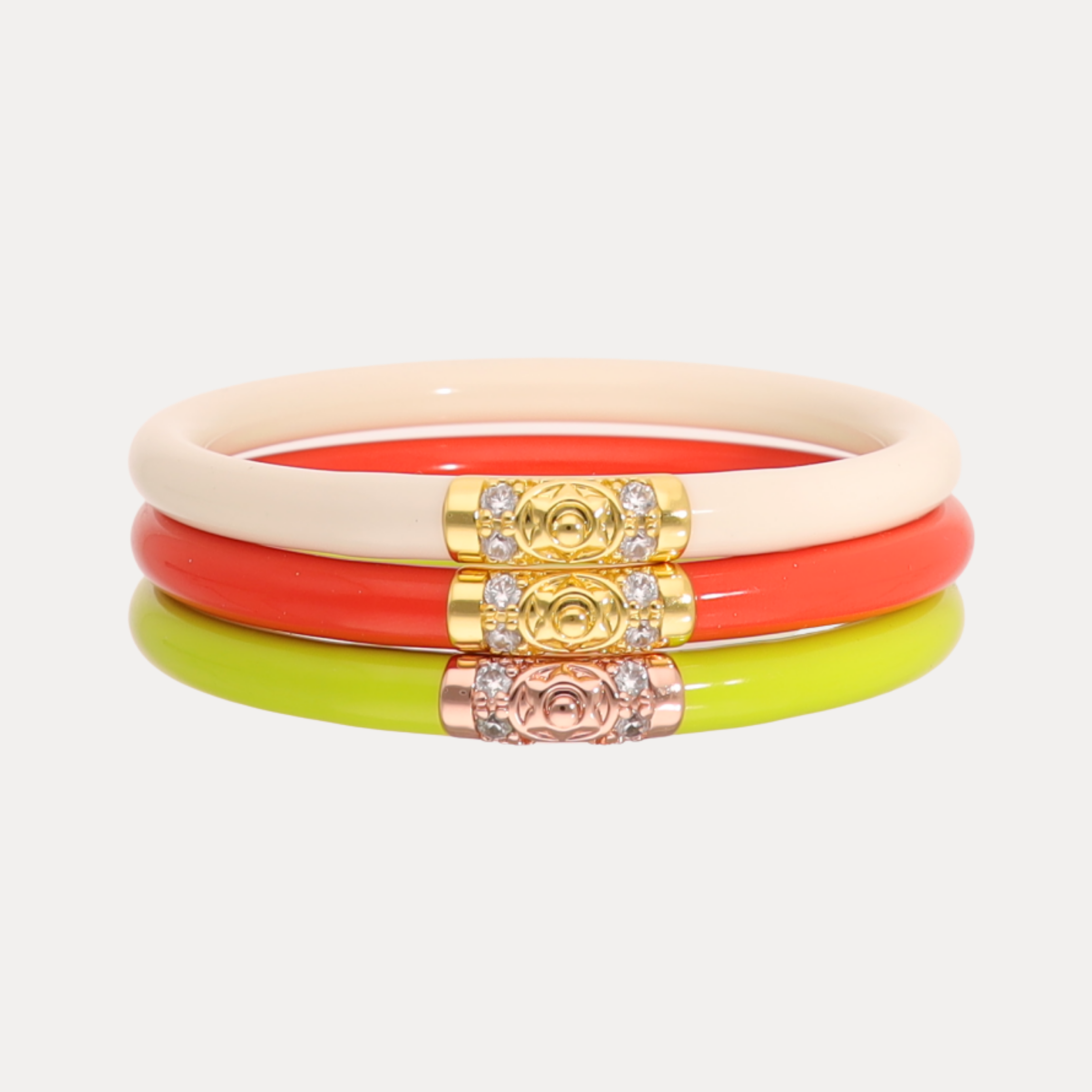 Set of colorful bangles with decorative elements on a light gray background