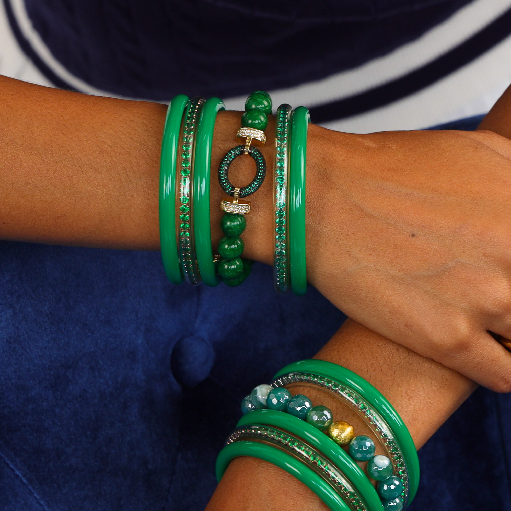 Elegant display of The Imperial Cosmos Bundle featuring vibrant green bangle bracelets and sparkling pavé spacers.