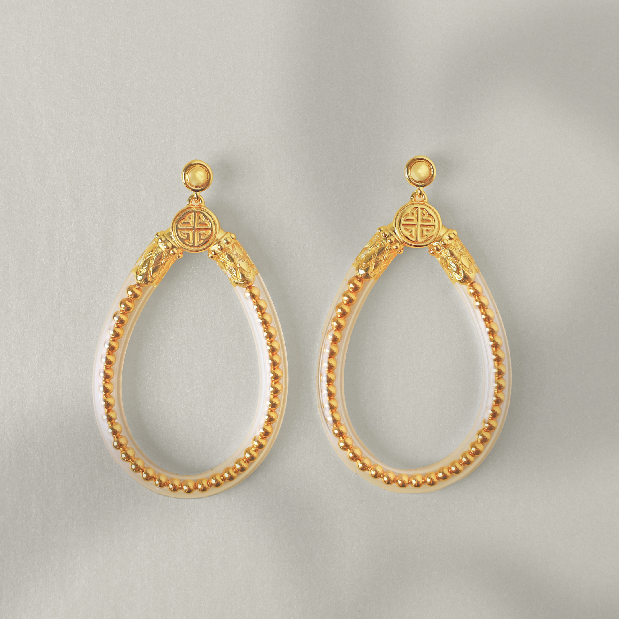 a pair of gold earrings