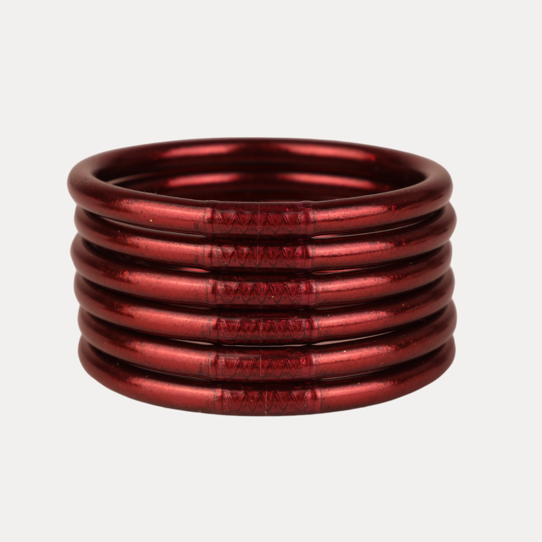 Stack of red metal springs on a light gray background