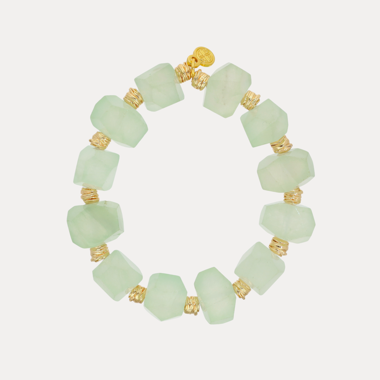Light green beaded bracelet with gold accents on a white background